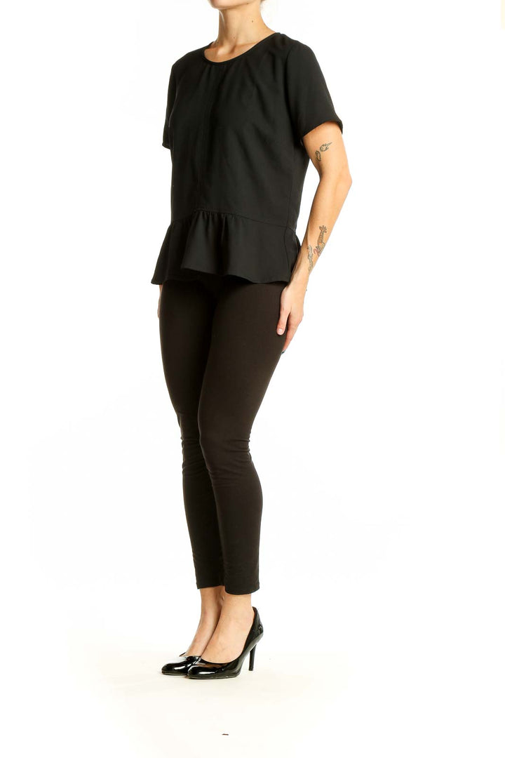 Front view of Ann Taylor black peplum top with short sleeves