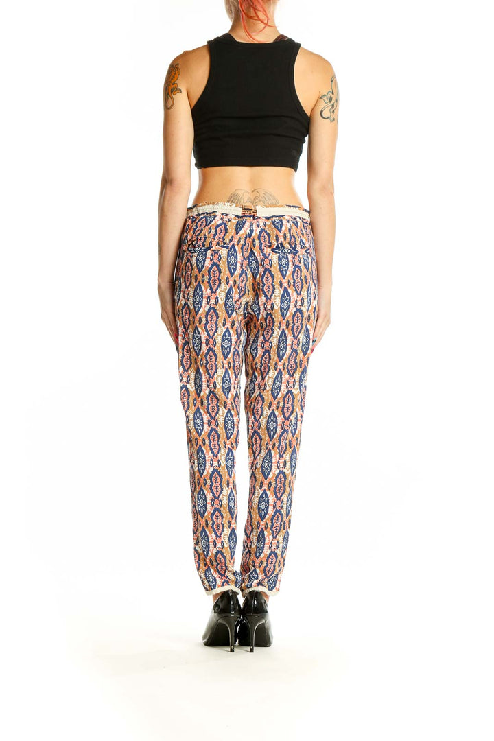 Side view of model wearing Pilcro and the Letterpress multicolor ikat print pants with black top