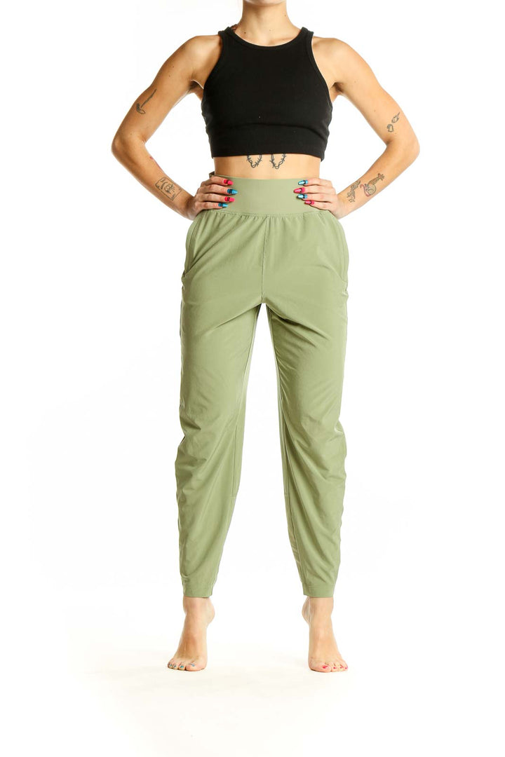 Front view of Athleta sage green high-waisted activewear pants