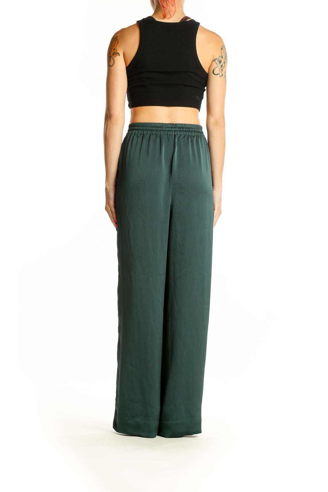 Side view of model wearing Madewell forest green wide-leg pants with black crop top