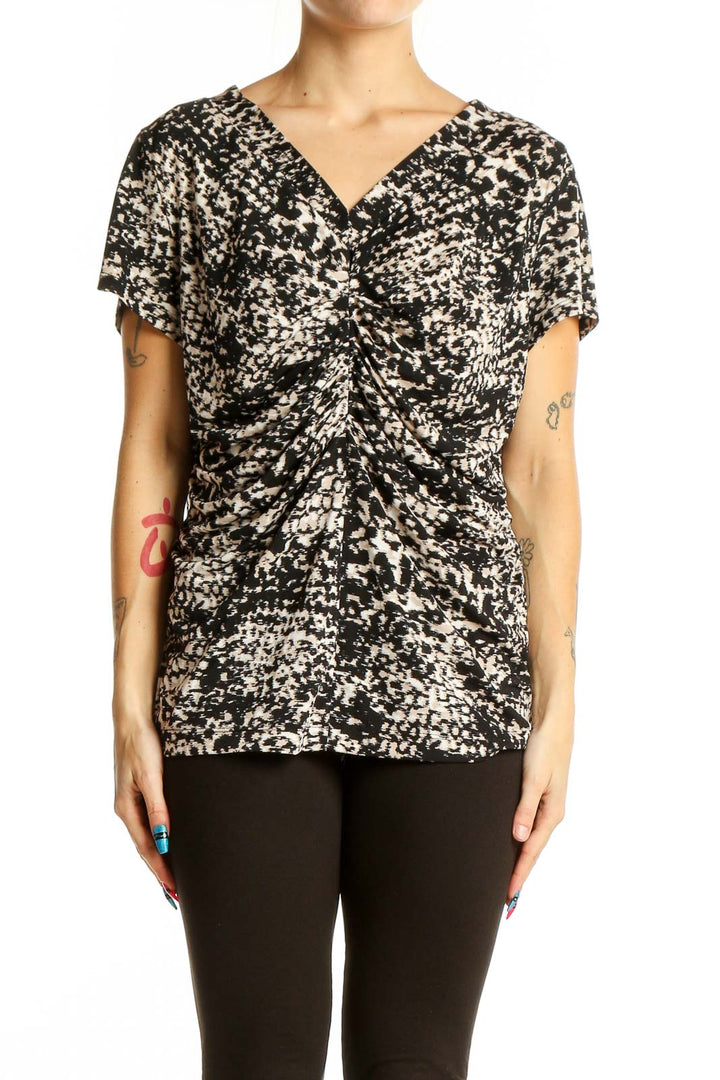 Front view of Alfani black and white speckled V-neck top with gathered front