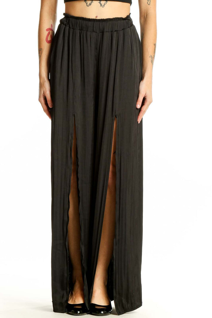 Front view of By Together black wide-leg pants with side slits