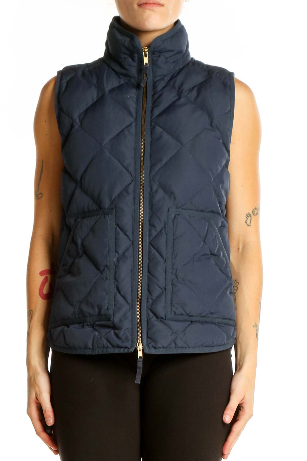 Front view of J.Crew navy quilted puffer vest on model