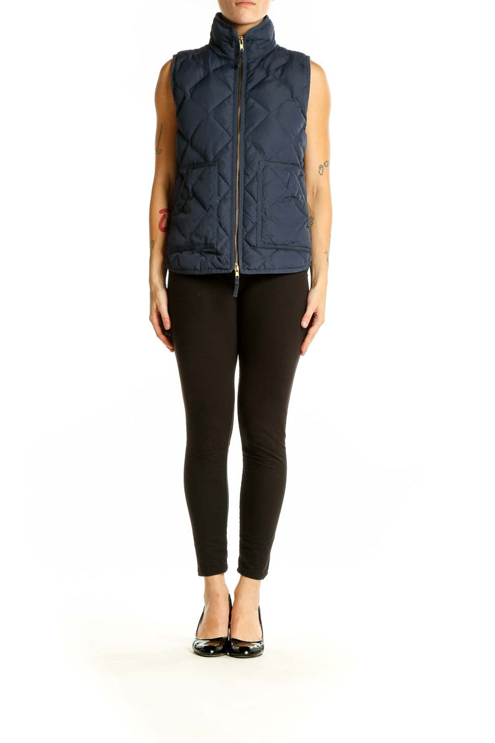 Front view of J.Crew navy quilted puffer vest on model