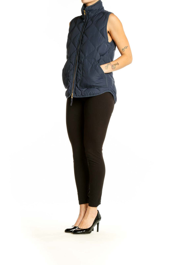 Front view of J.Crew navy quilted puffer vest on model