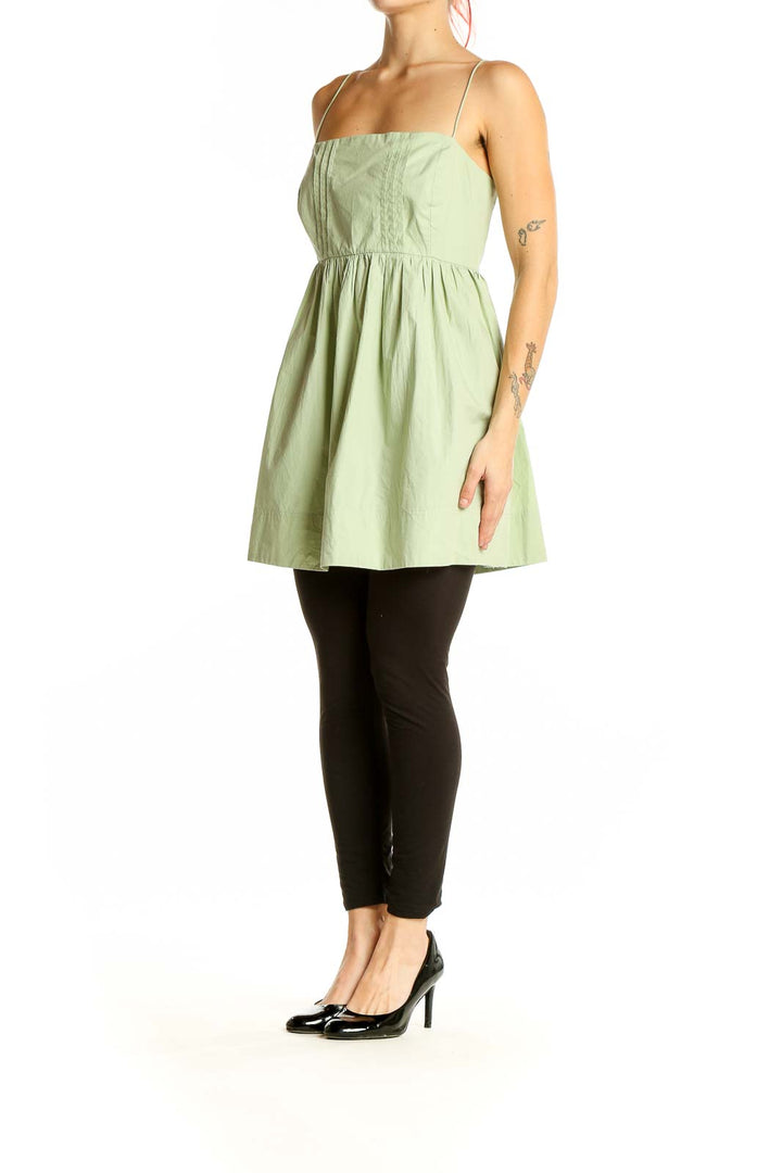 Front view of Maeve sage green cotton babydoll top with spaghetti straps