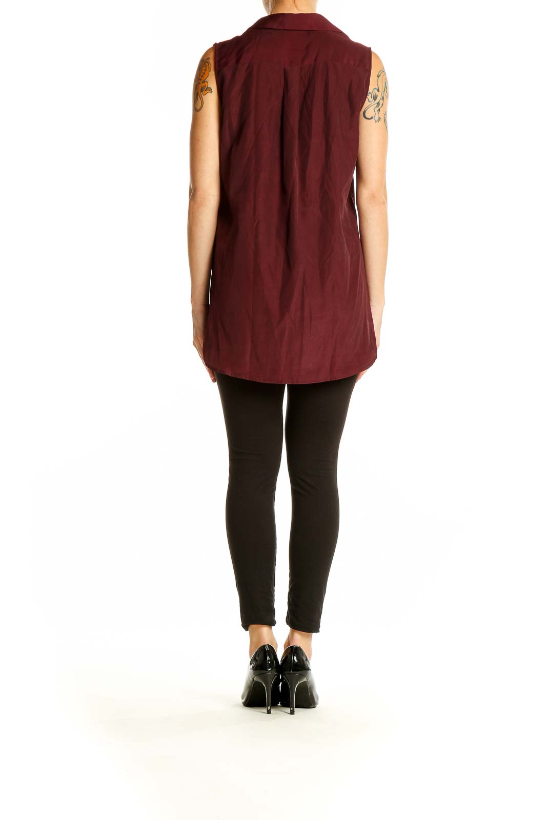 Side view of model wearing J.Crew burgundy sleeveless button-down blouse with black pants