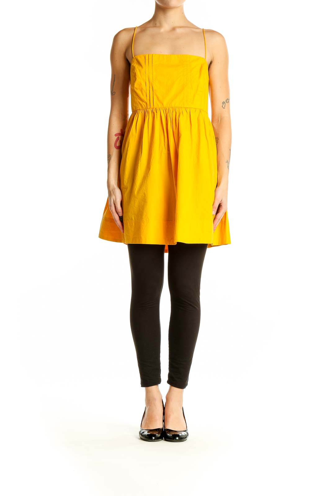 Front view of yellow cotton sundress with spaghetti straps and pleated bodice