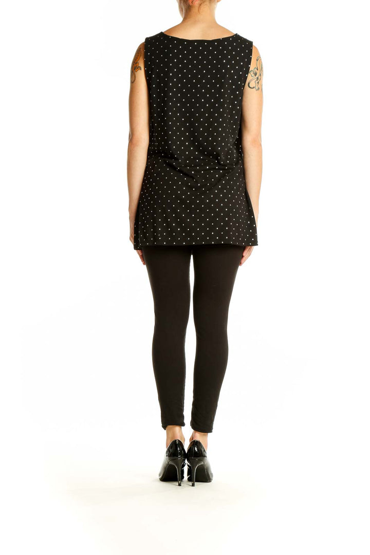 Back view of Venus black polka dot sleeveless top on model