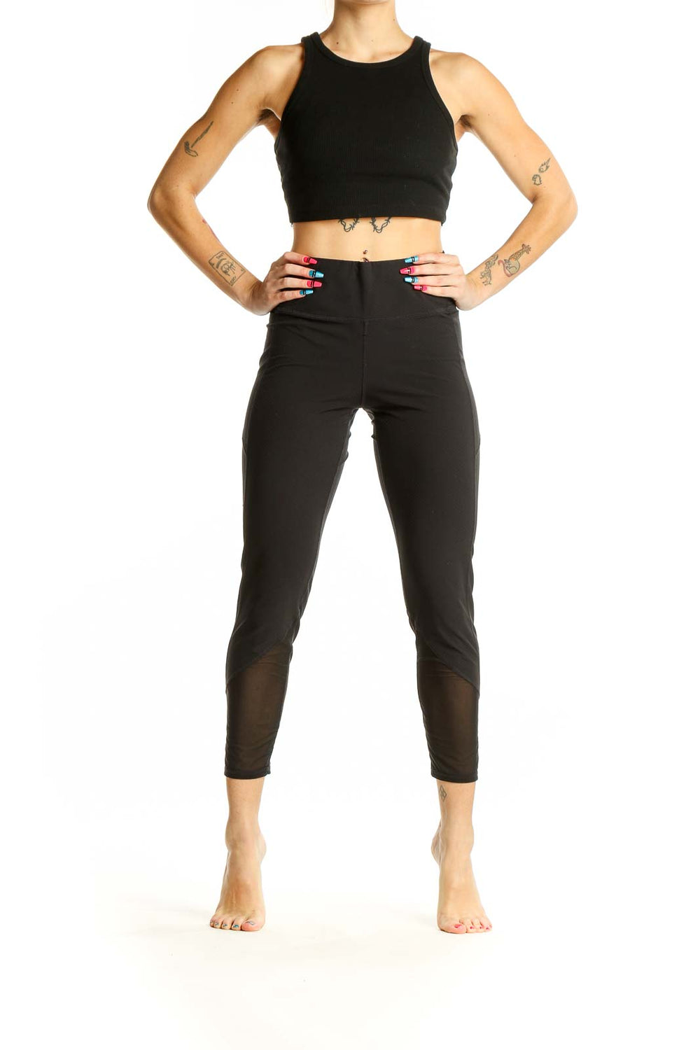 Front view of black Athleta cropped activewear leggings with mesh panels