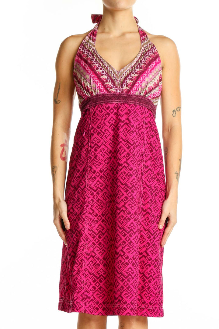 Front view of pink Athleta halter dress with geometric pattern and striped bodice