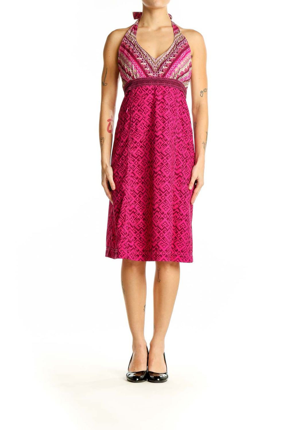 Front view of pink Athleta halter dress with geometric pattern and striped bodice