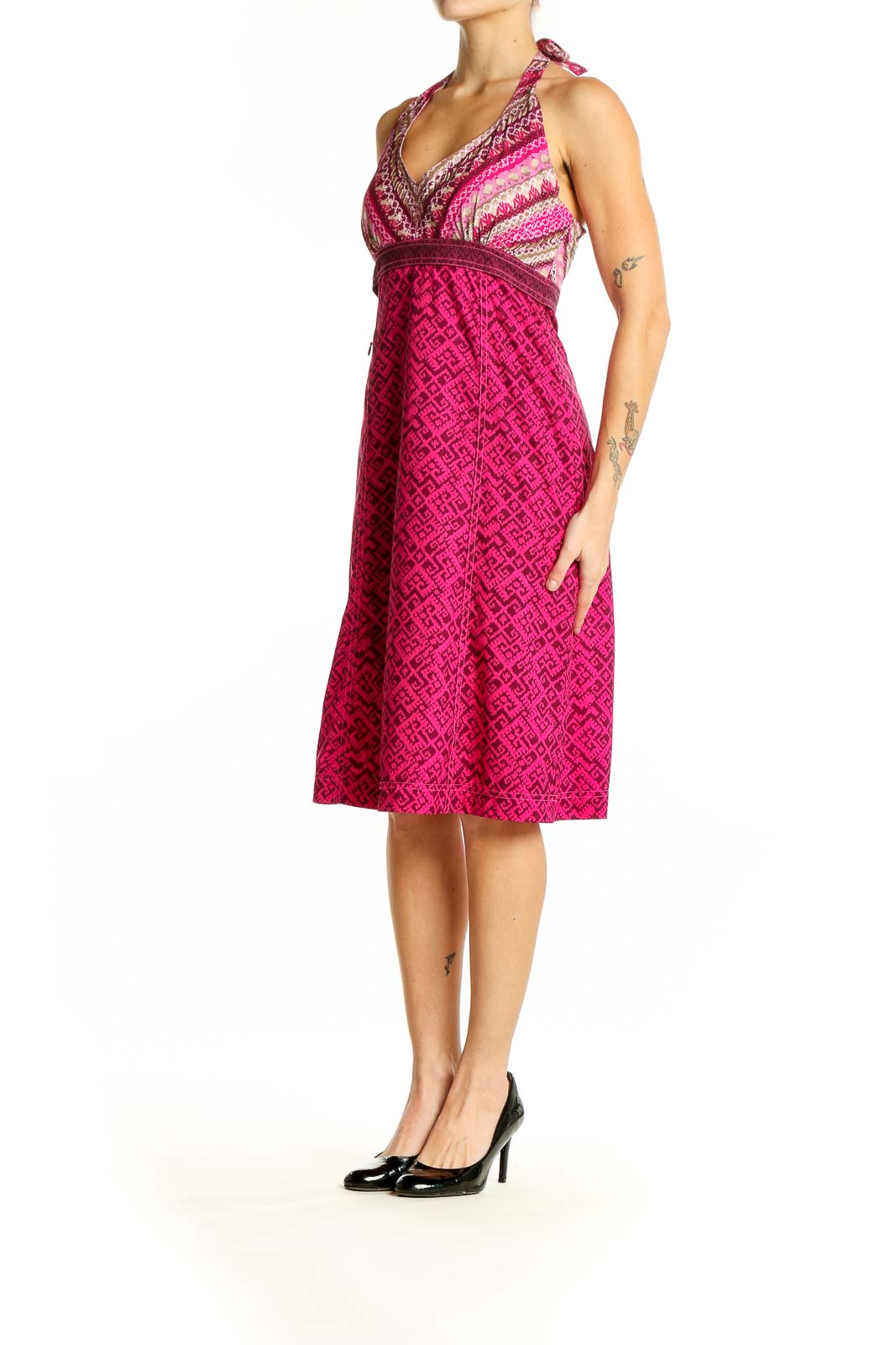 Front view of pink Athleta halter dress with geometric pattern and striped bodice