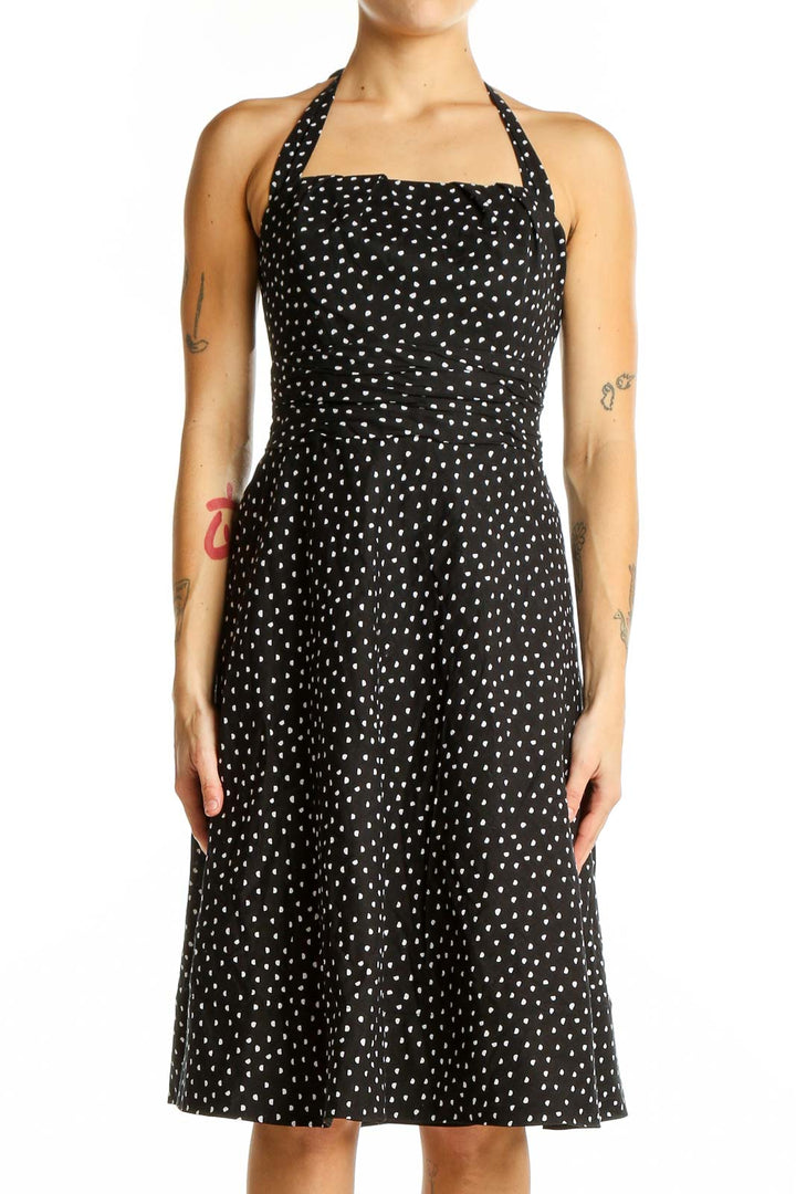 Front view of White House Black Market black polka dot halter dress