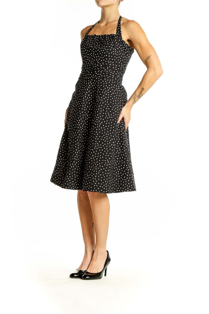 Front view of White House Black Market black polka dot halter dress