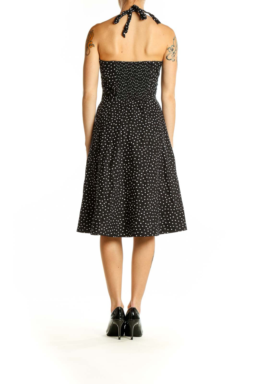 Side view of White House Black Market black polka dot halter dress