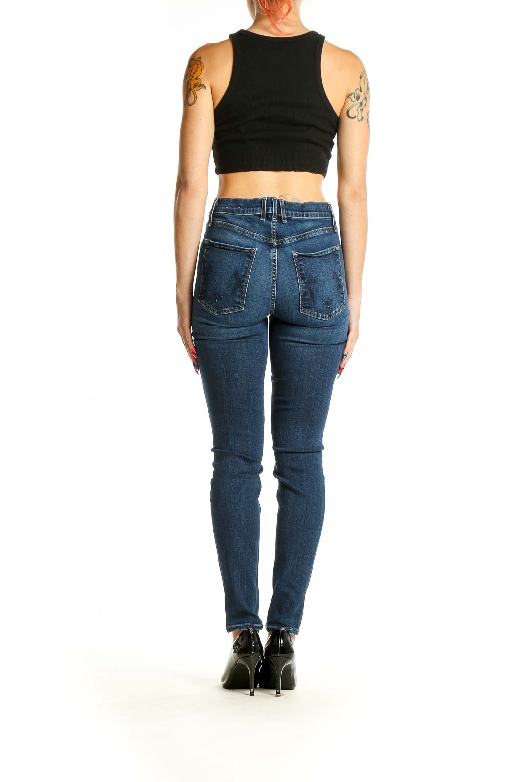 Back view of McGuire Denim blue slim fit jeans on model with black crop top