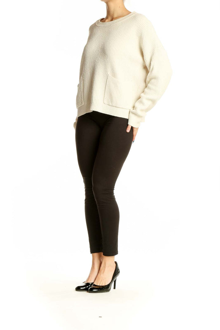 Front view of cream ribbed knit sweater with pockets from Madewell