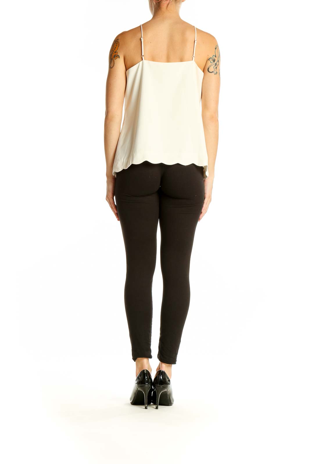 Side view of white J.Crew camisole top with black pants