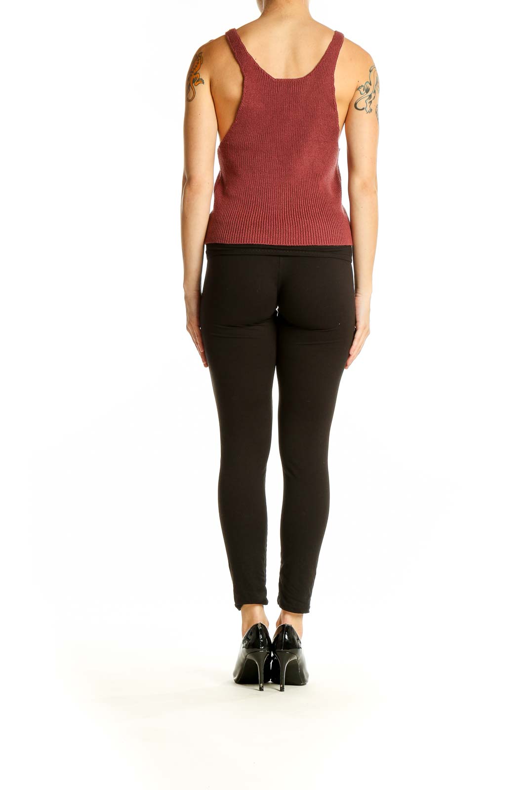 Side view of model wearing burgundy L.A. Hearts knit tank top with black pants