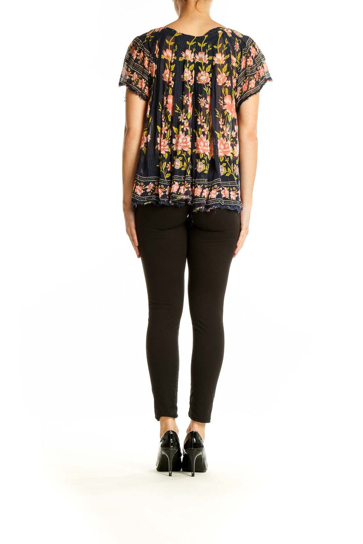 Back view of Free People navy floral peasant top showing relaxed fit