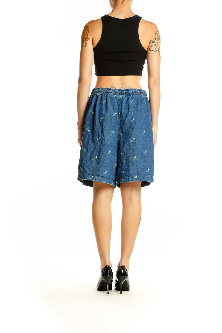 Side view of Erika & Co blue embroidered cotton shorts on model