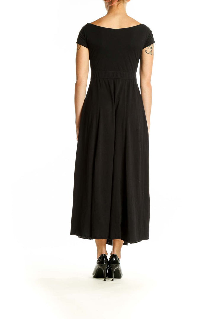 Side view of Free People black maxi dress showing flowing silhouette