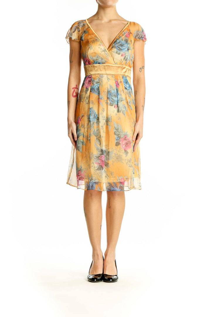 Front view of Neslay yellow floral wrap midi dress with V-neckline and cap sleeves