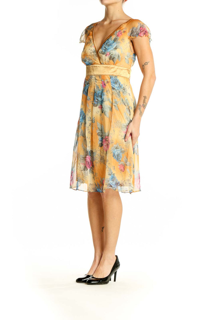 Front view of Neslay yellow floral wrap midi dress with V-neckline and cap sleeves