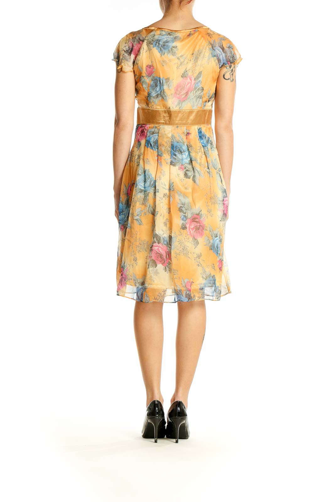 Back view of Neslay yellow floral wrap midi dress showing flowy skirt and all-over print