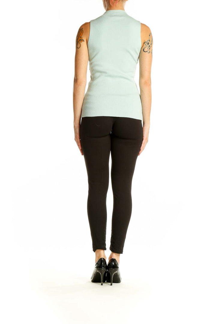 Side view of mint green sleeveless mock neck top by Ann Taylor Petites on model