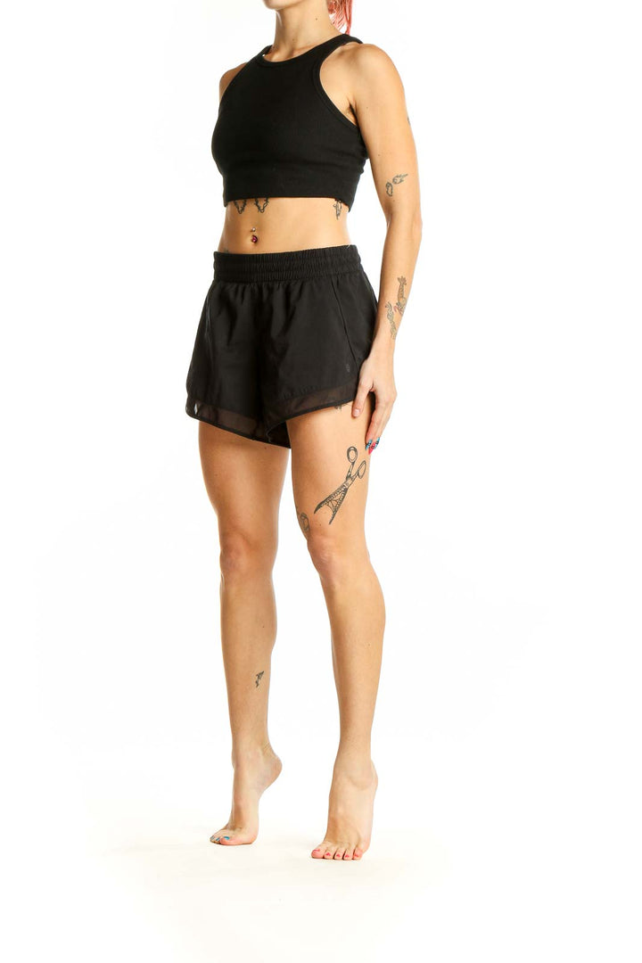 Front view of black Athleta activewear set with crop top and shorts