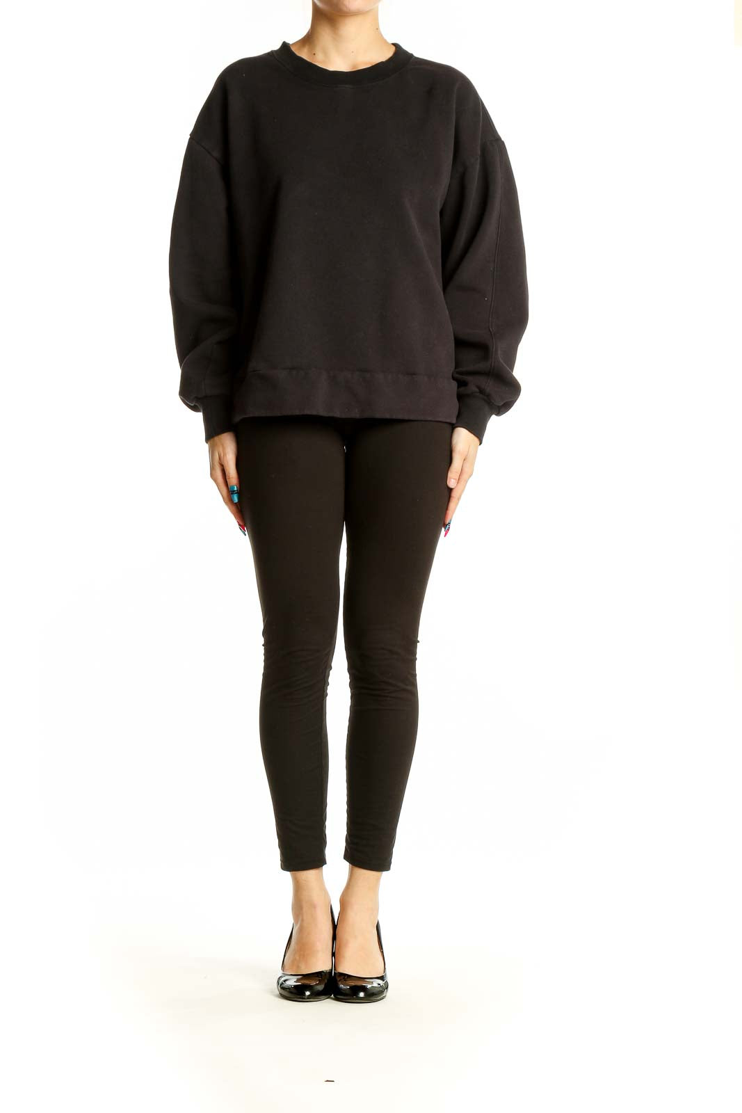 Front view of black oversized Athleta sweatshirt on model