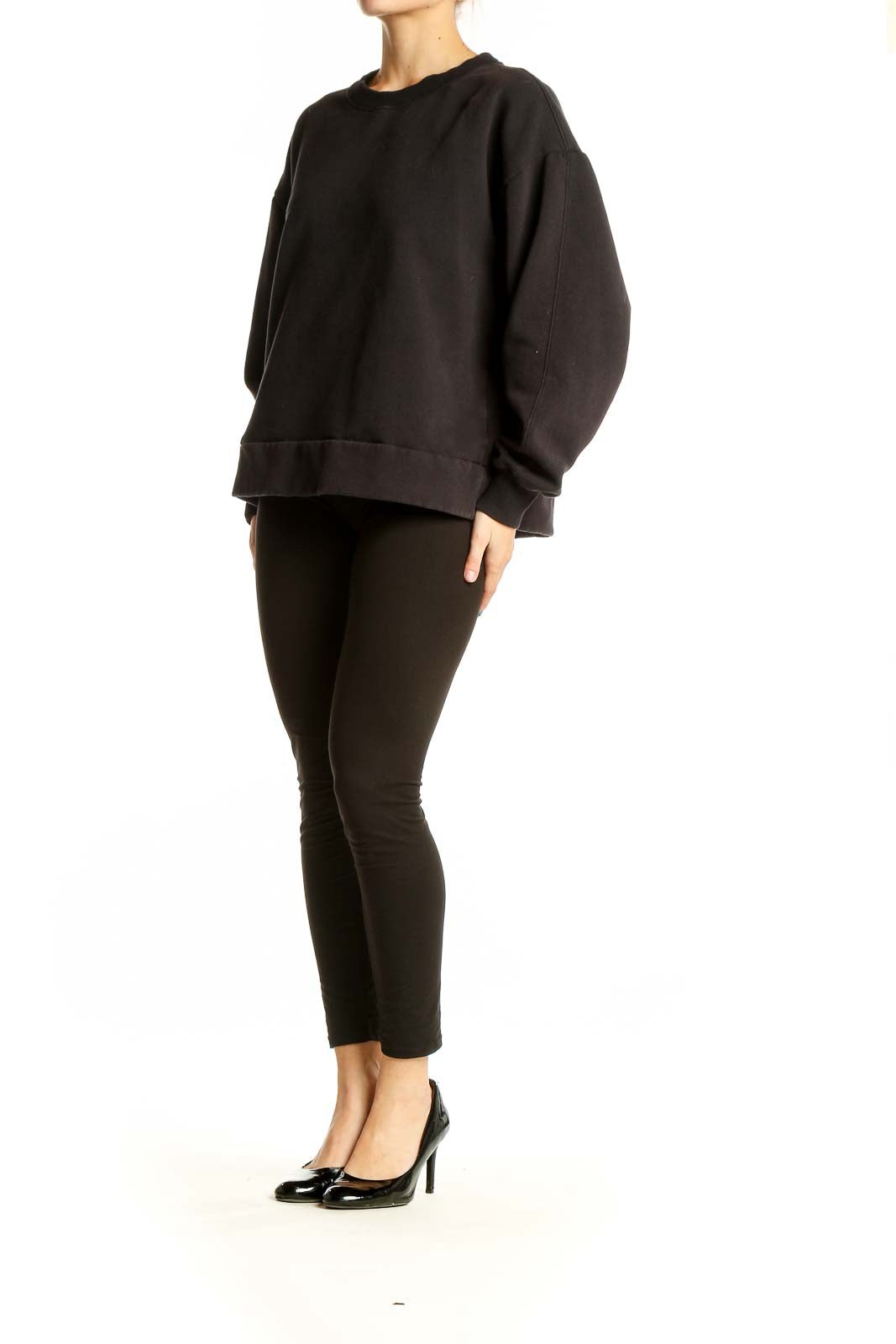 Front view of black oversized Athleta sweatshirt on model