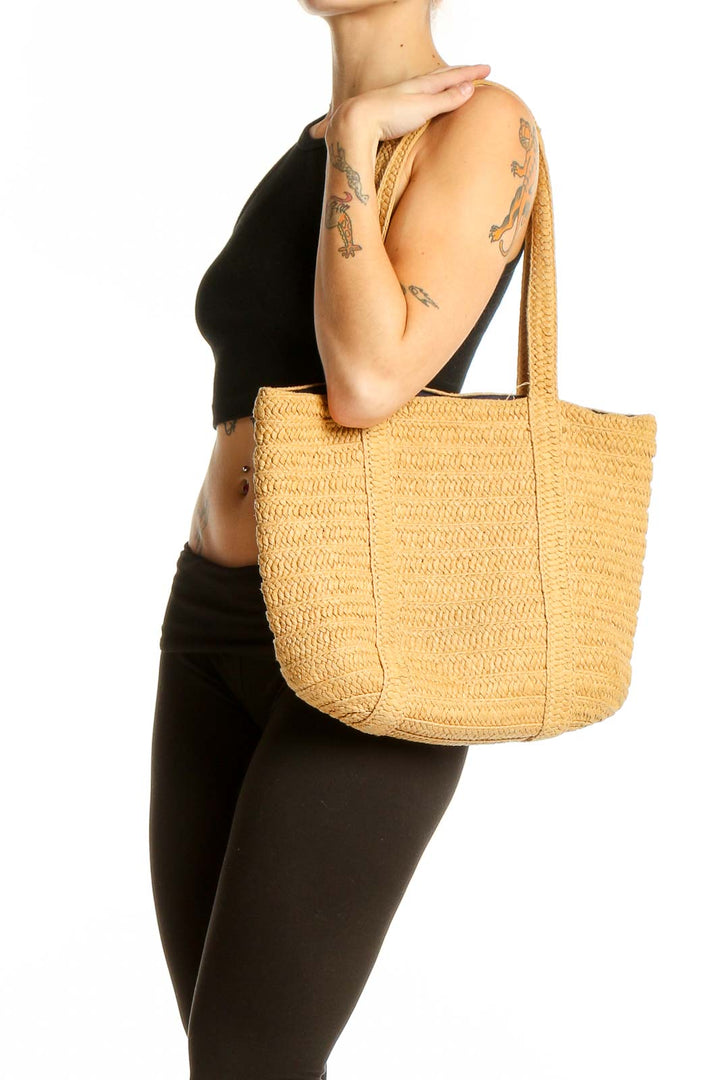 Front view of Draper James tan woven straw tote bag