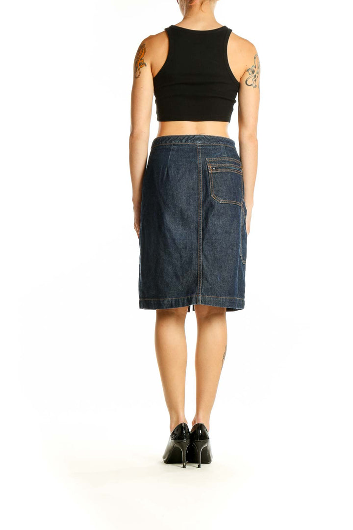 Side view of model wearing BCBG MaxAzria dark blue denim pencil skirt with black top