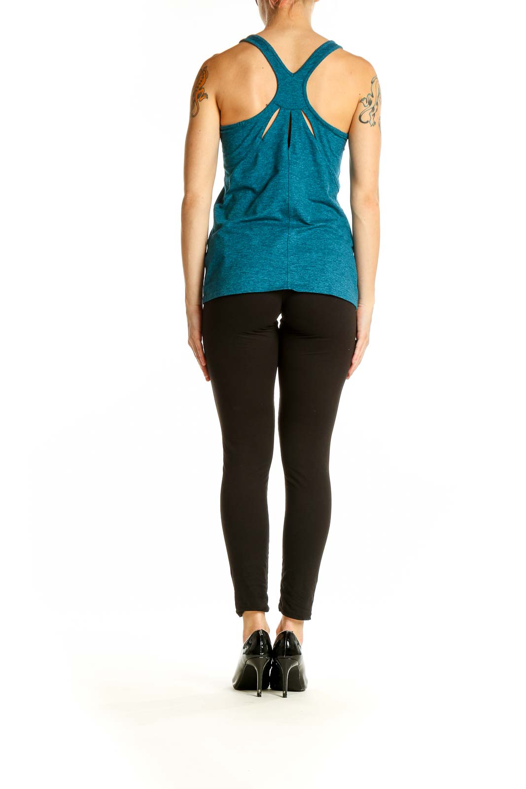 Side view of woman wearing teal Patagonia racerback tank top with black leggings