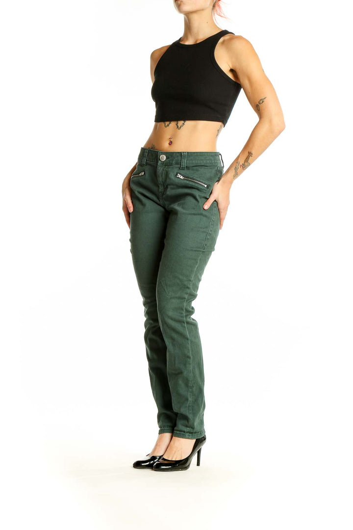 Front view of Cabi green slim fit denim jeans with zipper pockets