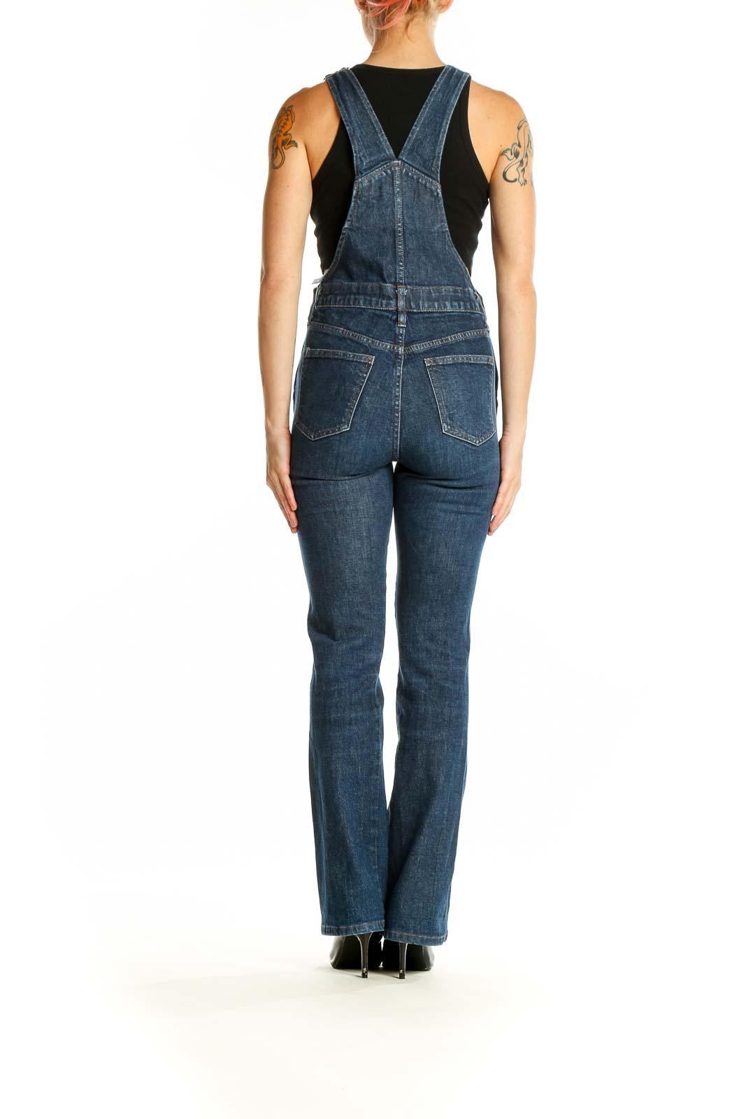 Side view of Madewell blue denim straight-leg overalls on model