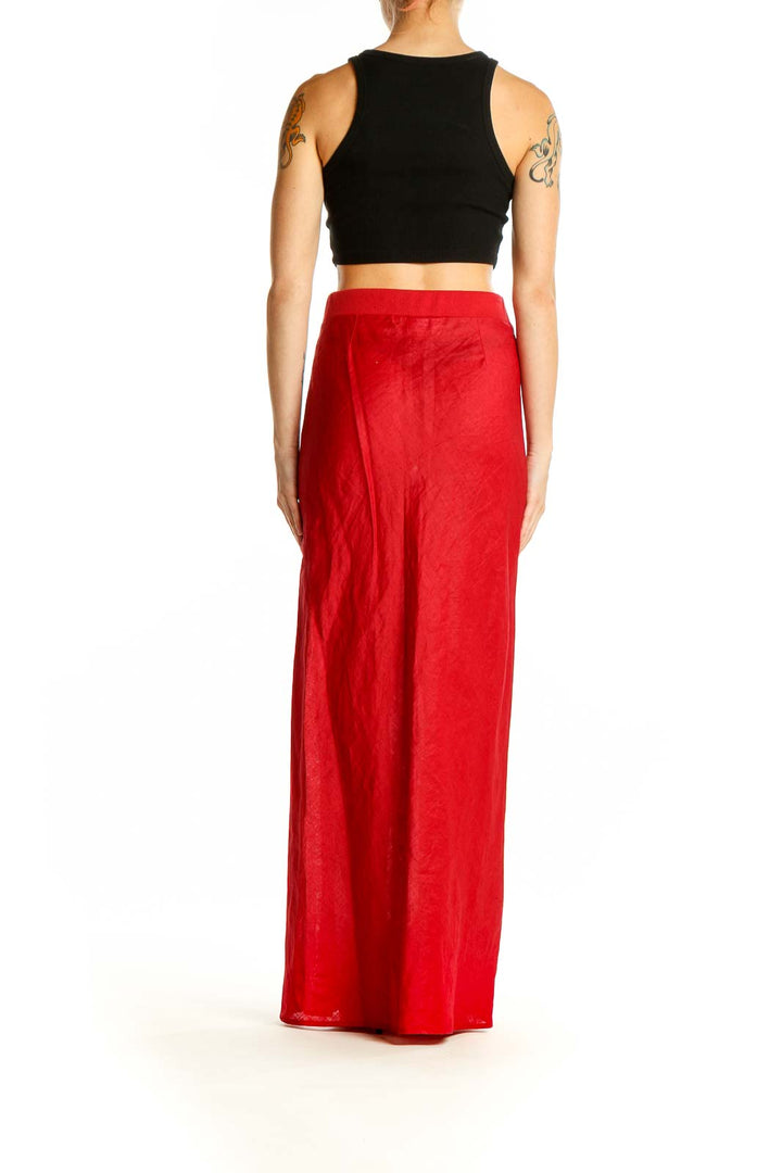 Side view of red Mango maxi skirt on model with black crop top