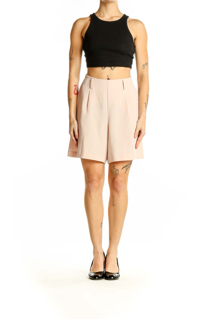 Front view of blush Uniqlo high-waisted pleated dress shorts