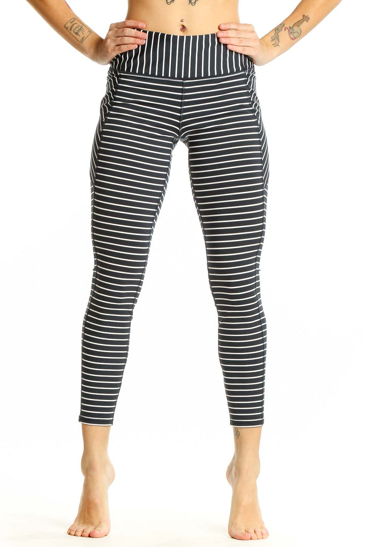 Front view of Athleta black and white striped athletic leggings on model