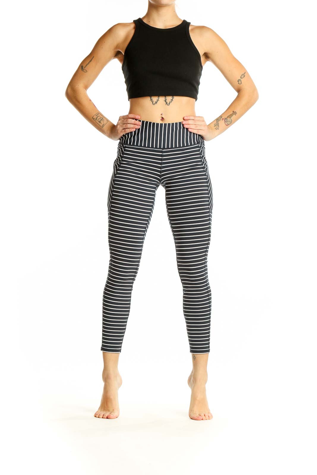 Front view of Athleta black and white striped athletic leggings on model