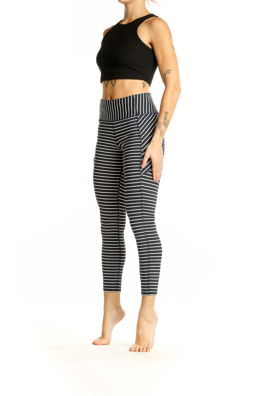 Front view of Athleta black and white striped athletic leggings on model