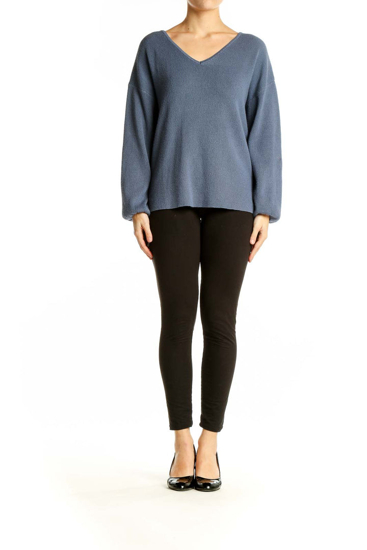 Front view of SilkRoll blue ribbed V-neck sweater on model