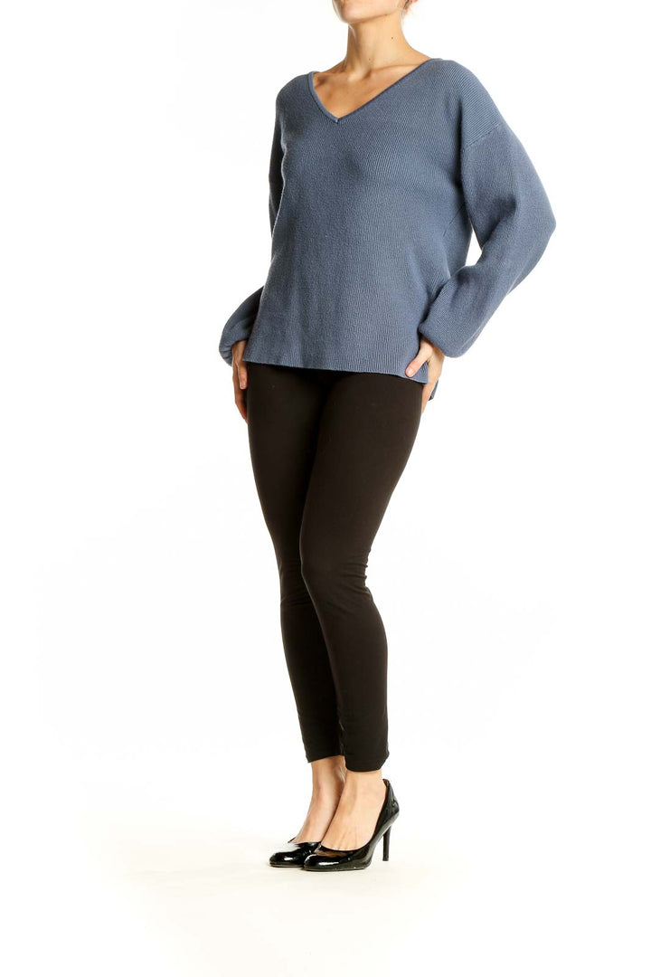 Front view of SilkRoll blue ribbed V-neck sweater on model