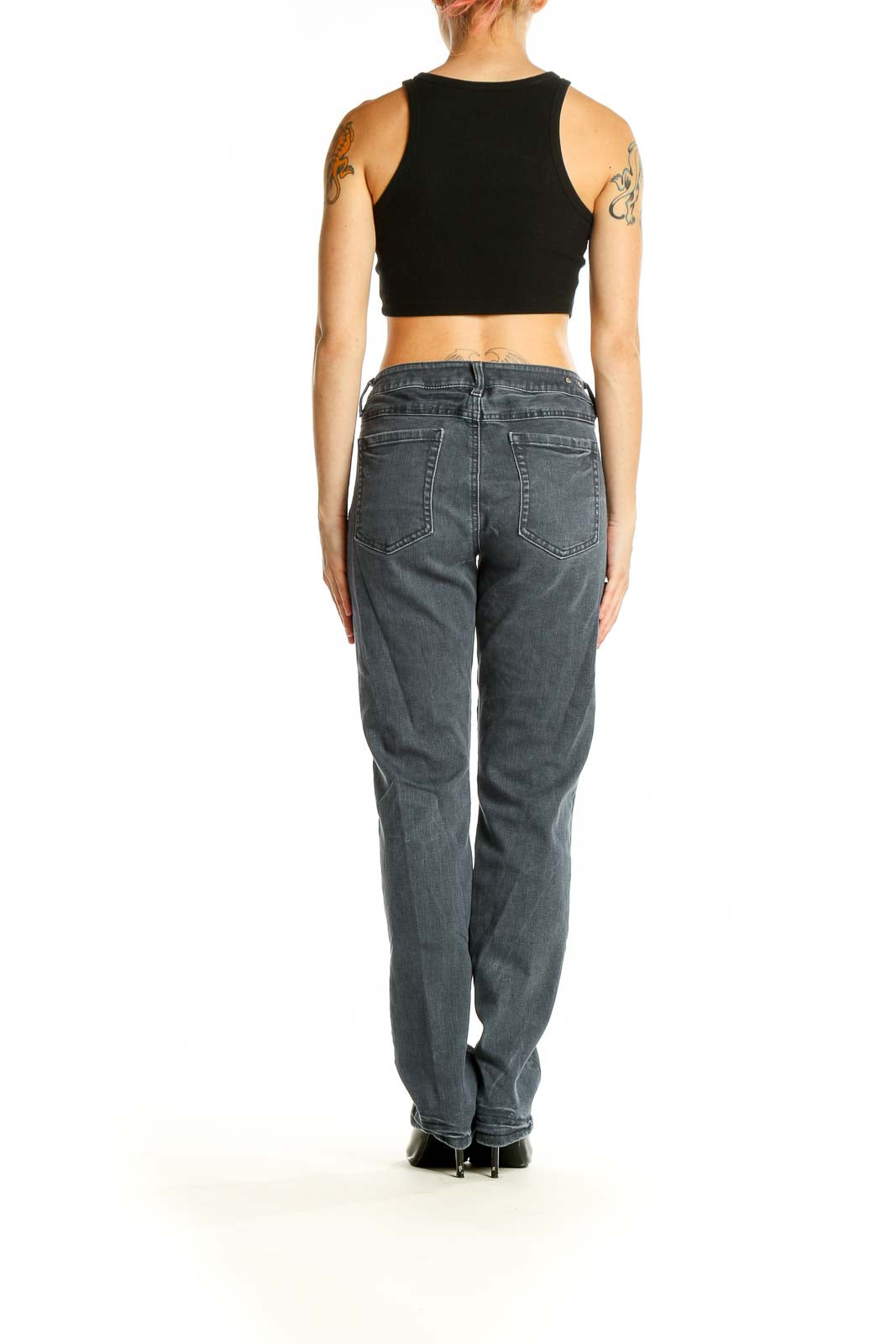 Back view of Cabi gray straight leg jeans on model with black crop top