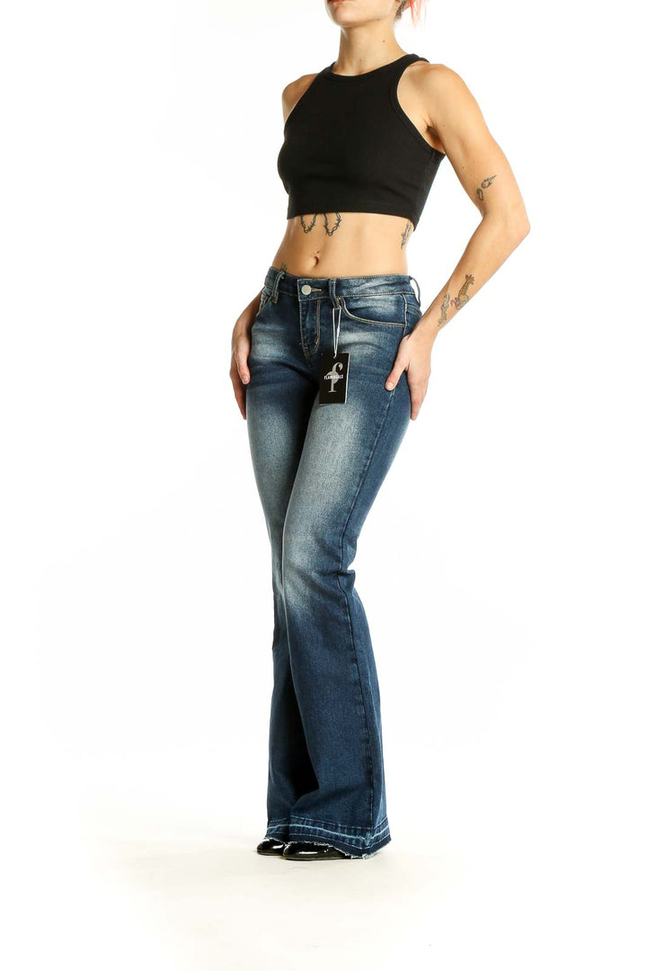 Front view of Flamingals blue faded flare jeans on model