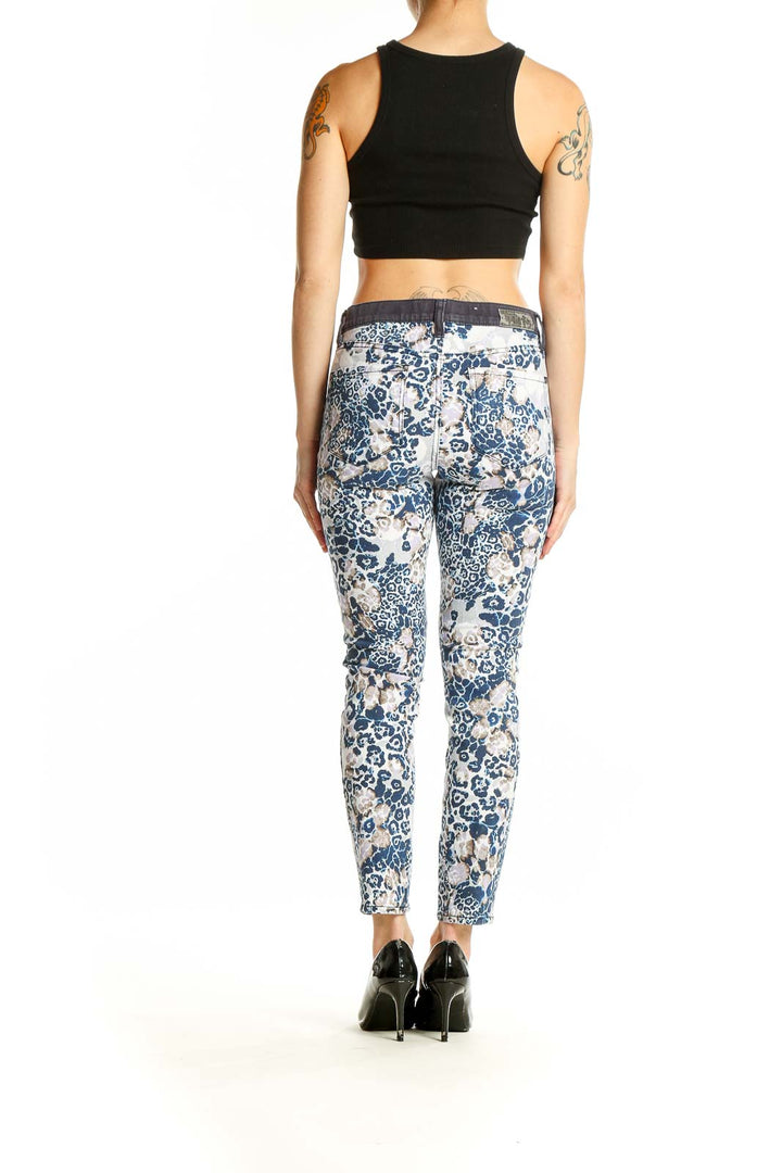 Side view of model wearing DKNY blue and white floral leopard print slim-fit jeans