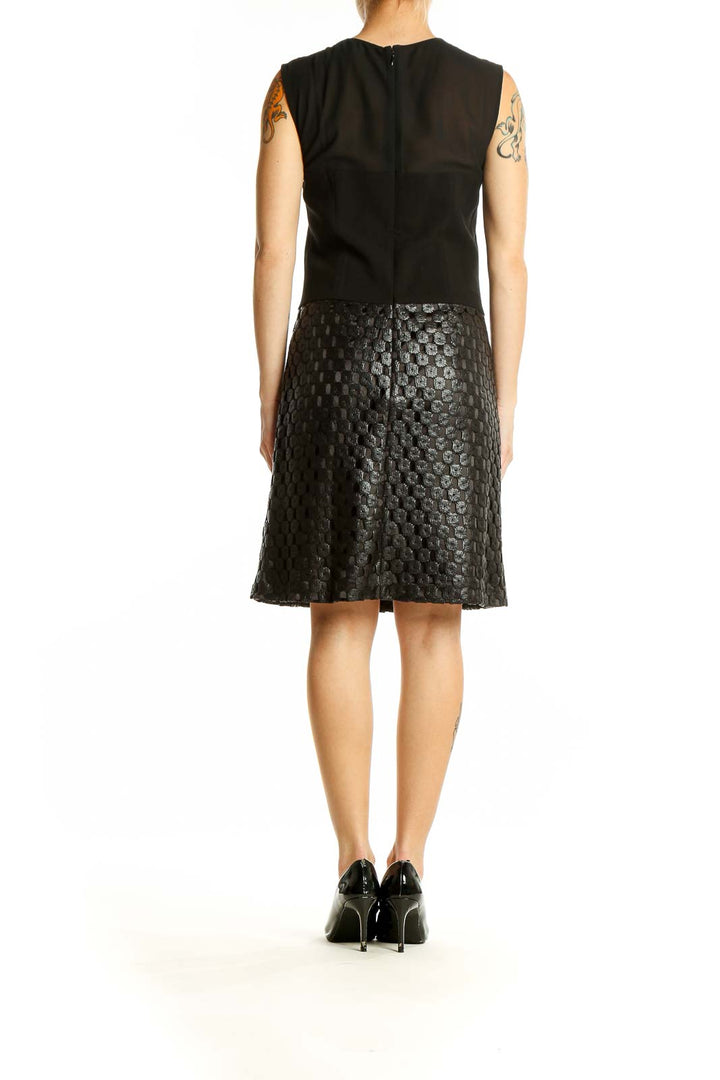 Back view of Banana Republic black sleeveless cocktail dress showing textured skirt detail